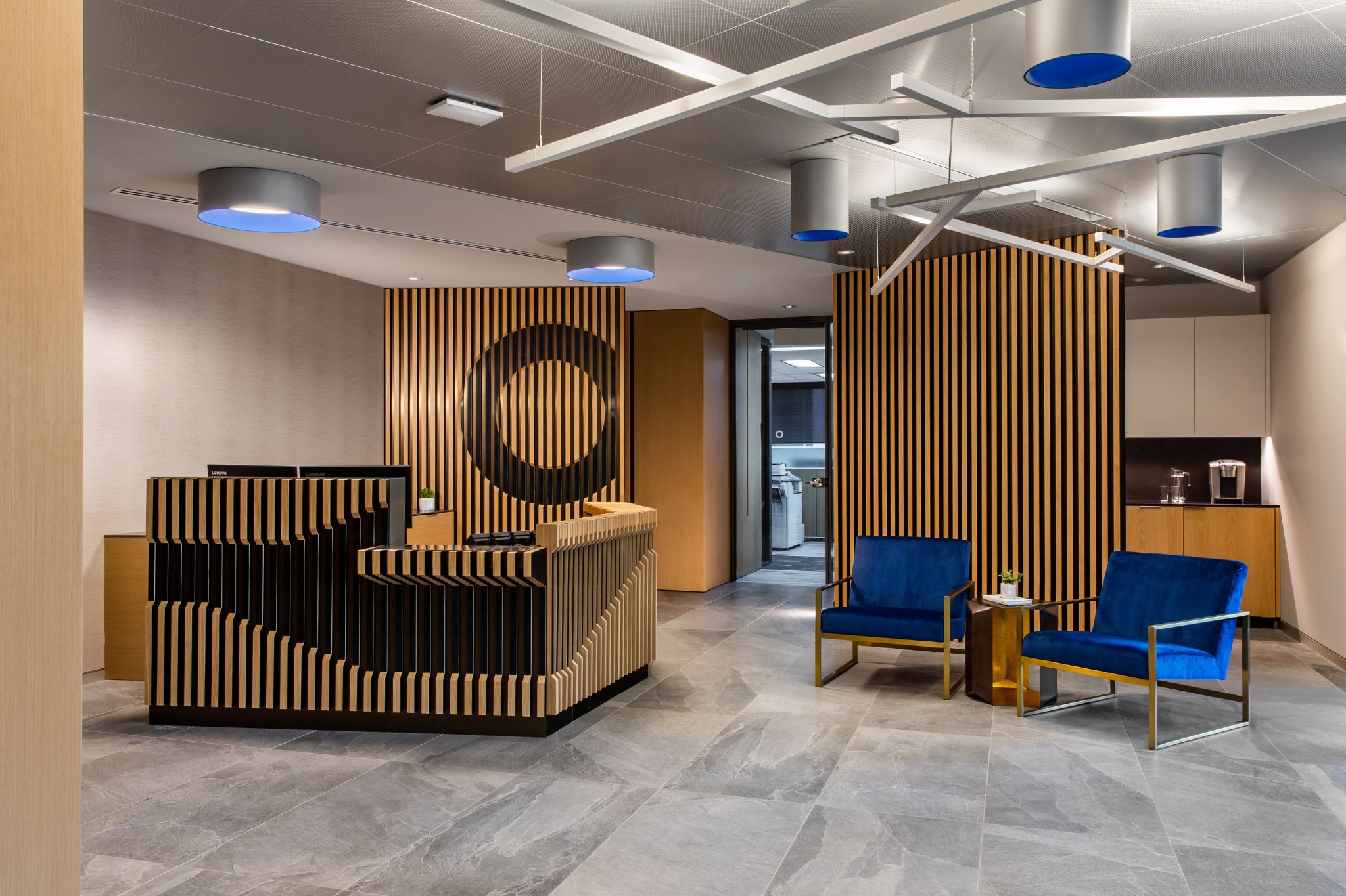 The top of a staircase with a wooden planter to the side and a large TV as you go down the stairs