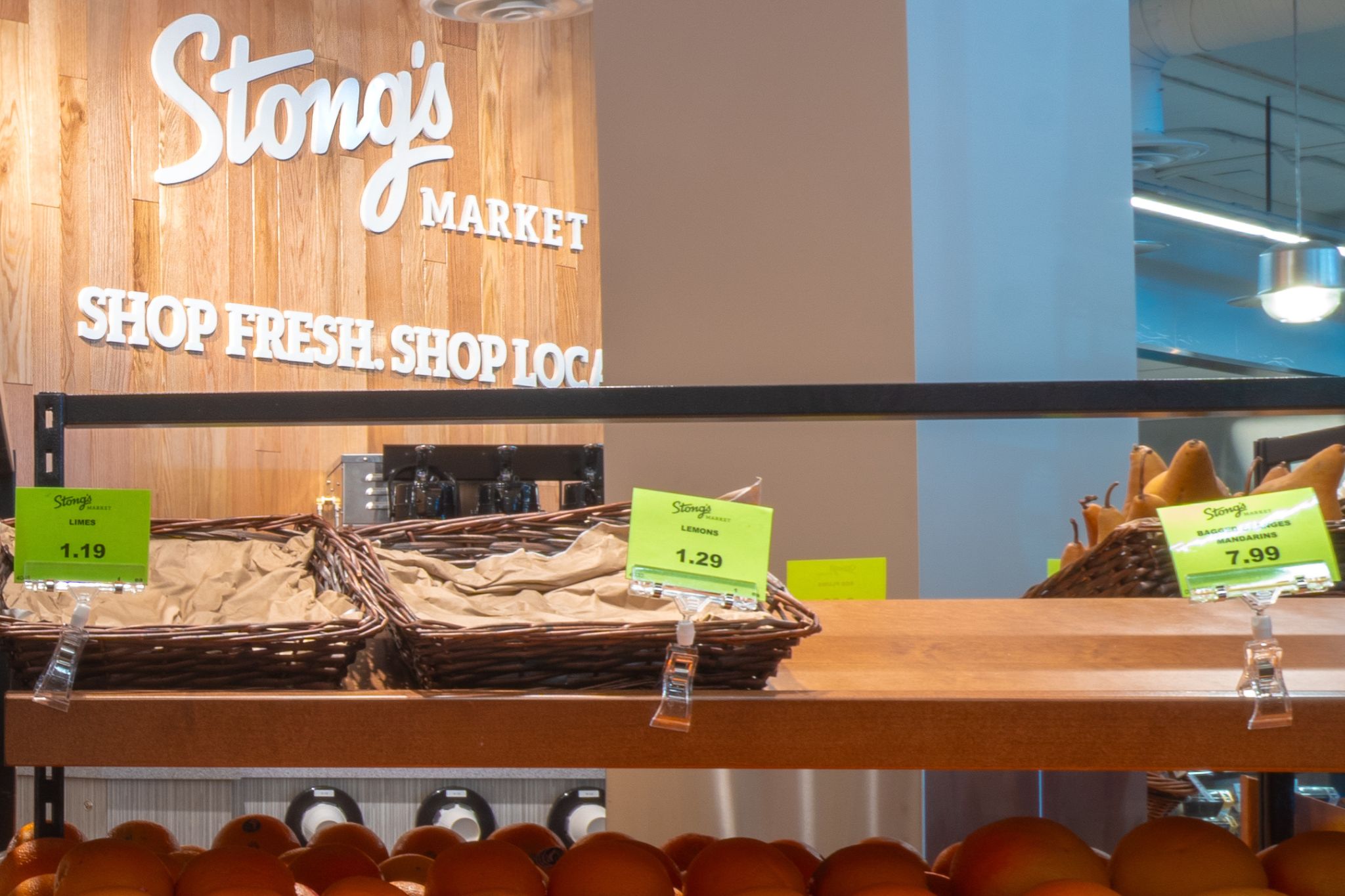 The top of a staircase with a wooden planter to the side and a large TV as you go down the stairs